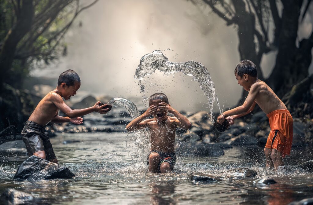 children finding joy laughing and playing in a pond